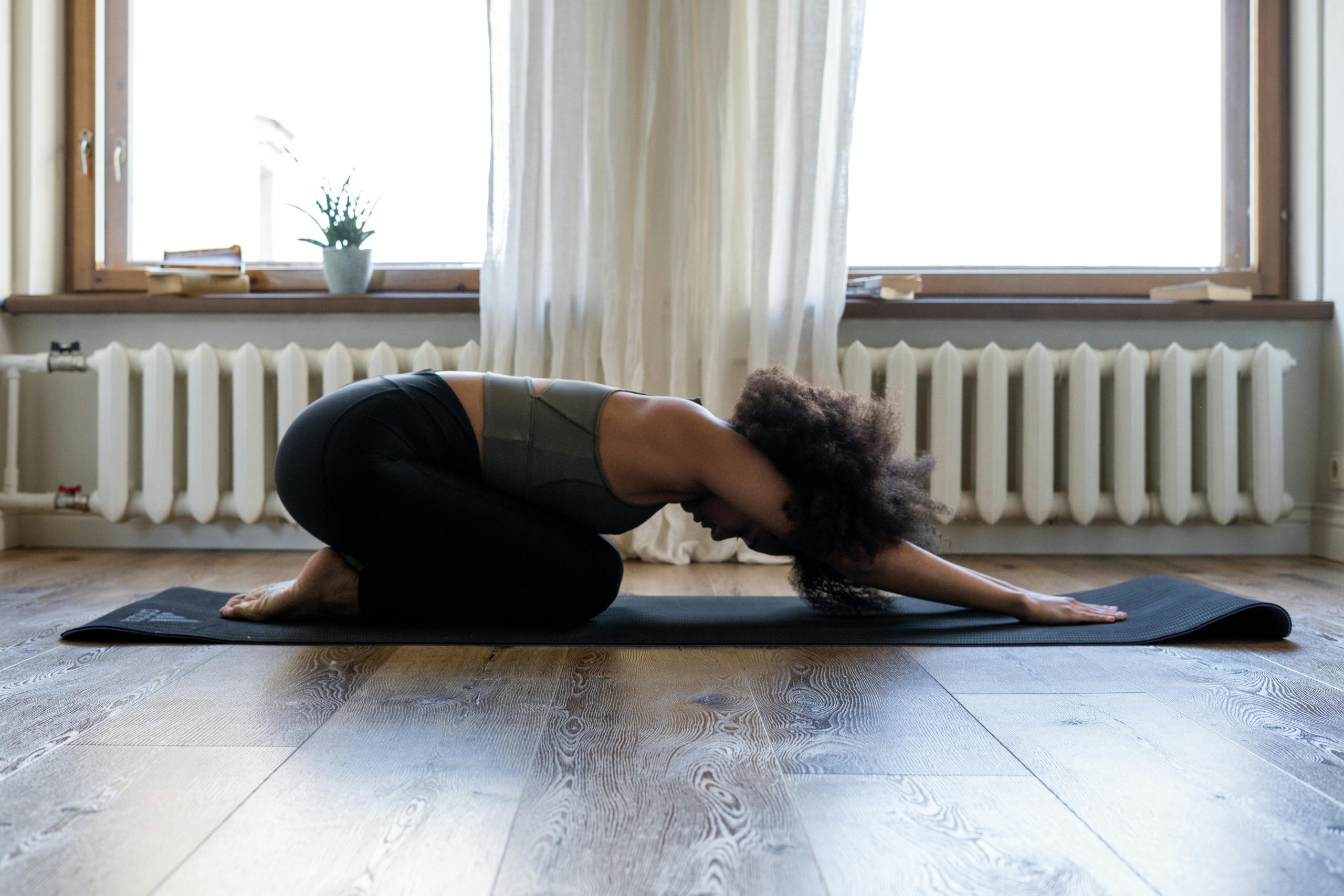 pexels-photo-4056513-4056513 Woman practicing yoga at home on a mat in a cozy room. Embracing fitness and wellness indoors.
