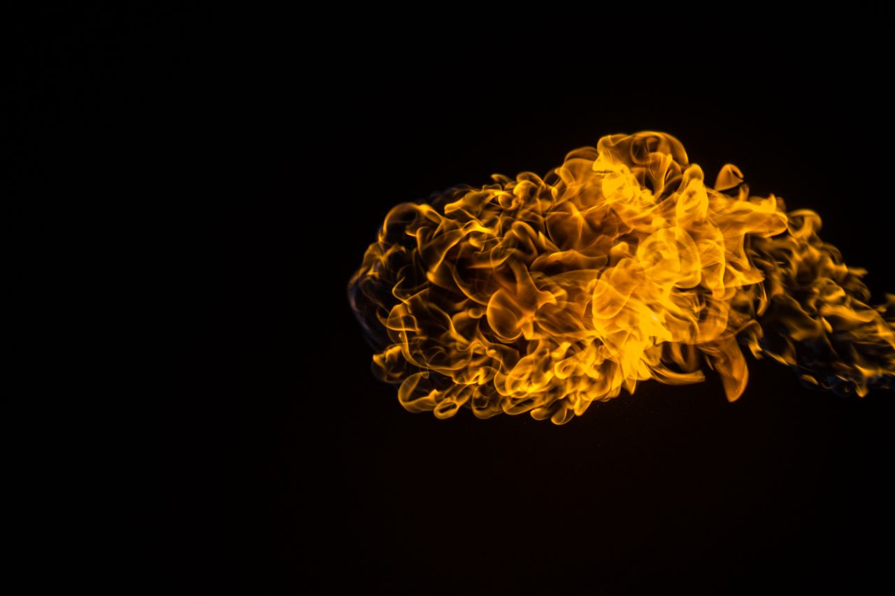 A vivid swirl of flames against a dark background, showcasing dynamic energy and warmth.
